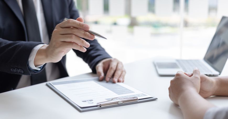 Close-up of business discussion during contract review, illustrating risks of spain peo arrangements