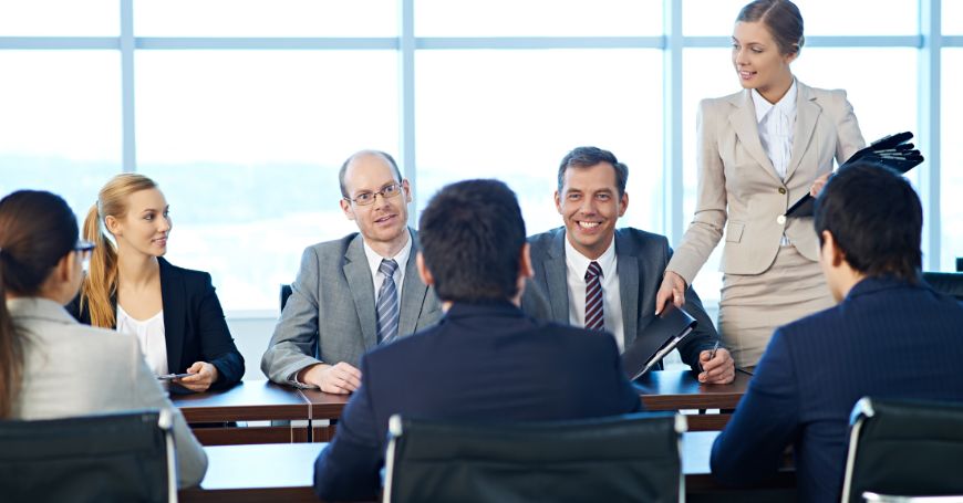 Group of business professionals discussing legal procedures to purchase shares in a spanish company.
