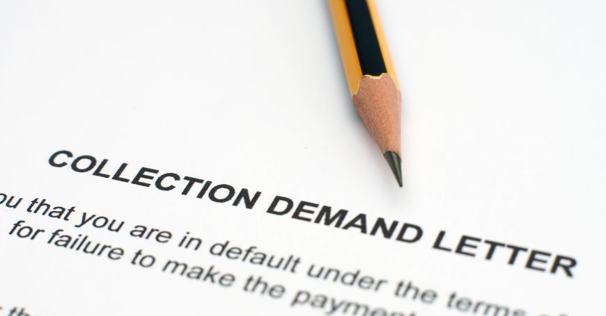 Close-up of a Demand Letter for Payment in Spain with a pencil resting on the paper